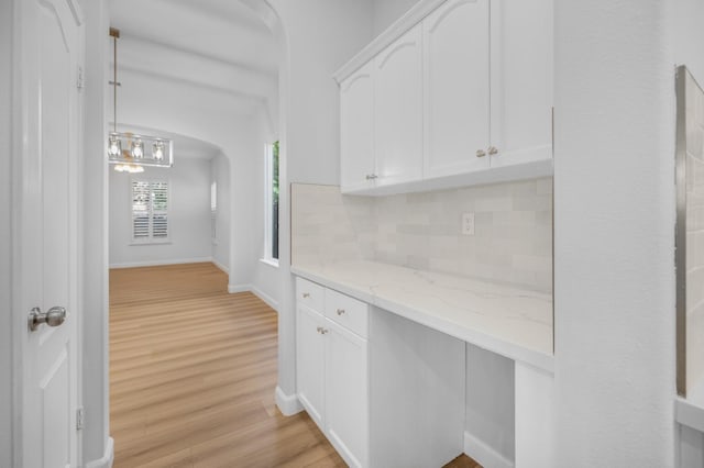 hallway with light wood-style floors and baseboards