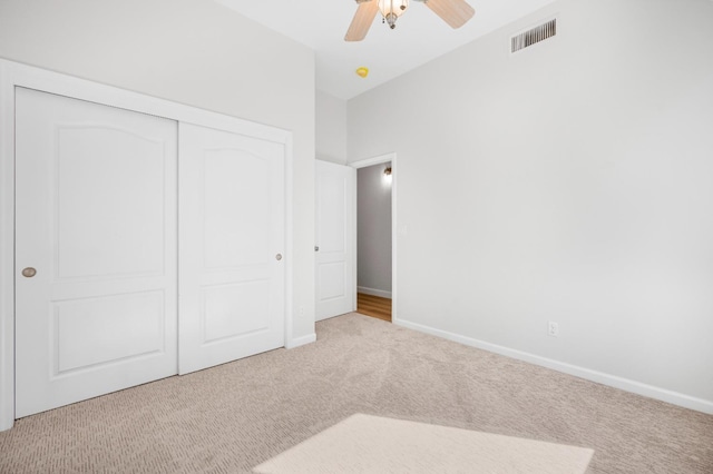 unfurnished bedroom featuring a closet, visible vents, baseboards, and carpet