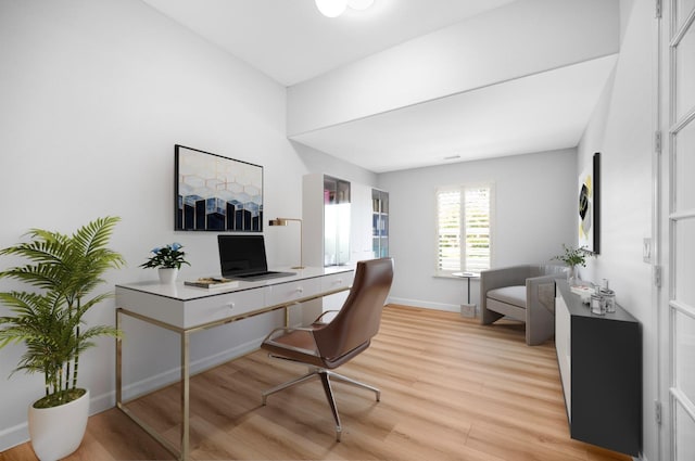 office space featuring light wood-type flooring and baseboards