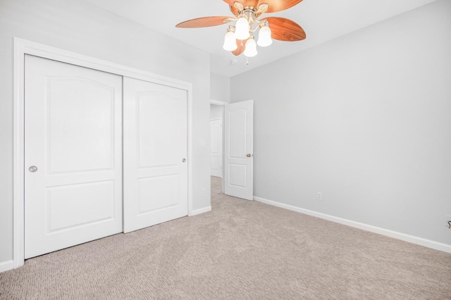 unfurnished bedroom with a closet, ceiling fan, baseboards, and carpet