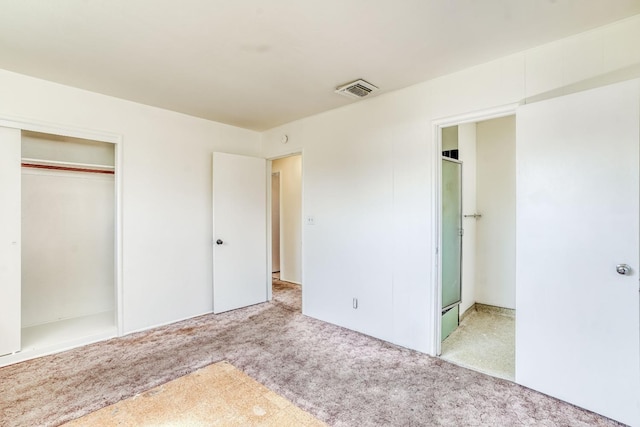 unfurnished bedroom featuring a closet, visible vents, and carpet floors