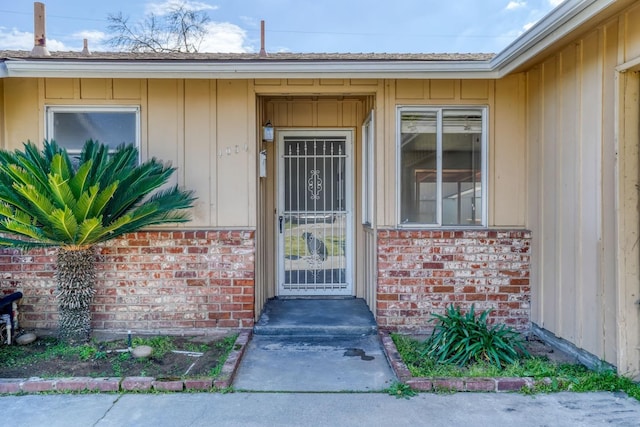 entrance to property featuring brick siding