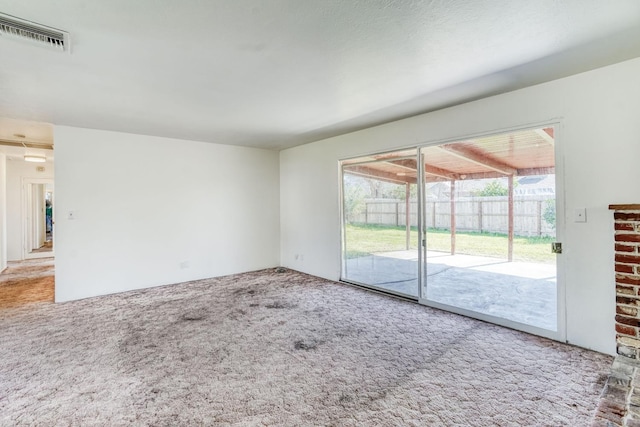 unfurnished living room featuring visible vents and carpet floors