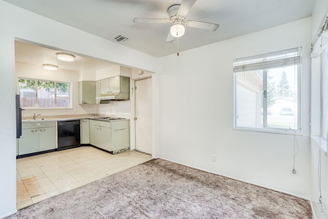 kitchen featuring visible vents, light carpet, black appliances, a sink, and light countertops