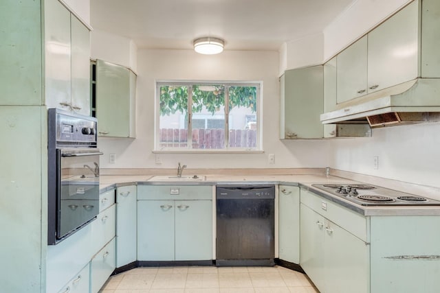 kitchen featuring under cabinet range hood, black appliances, light countertops, and a sink