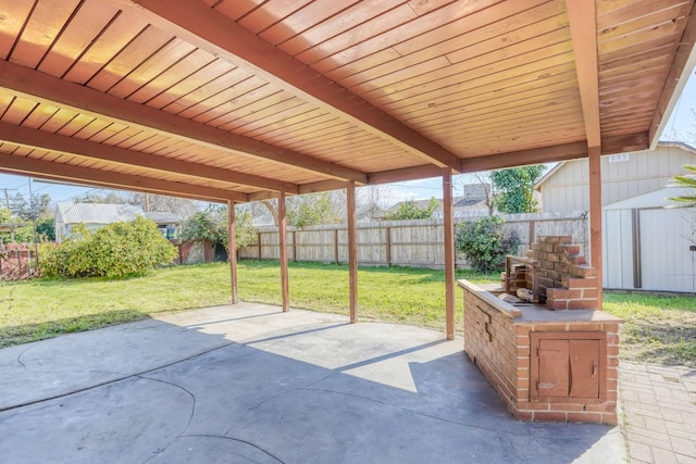 view of patio / terrace with a fenced backyard, a shed, and an outdoor structure