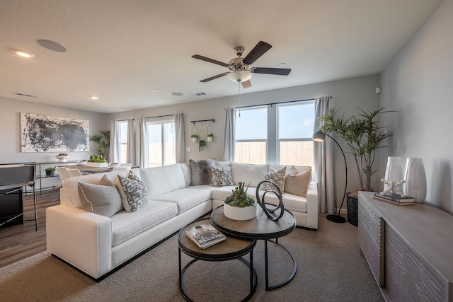 living area with recessed lighting, visible vents, and ceiling fan