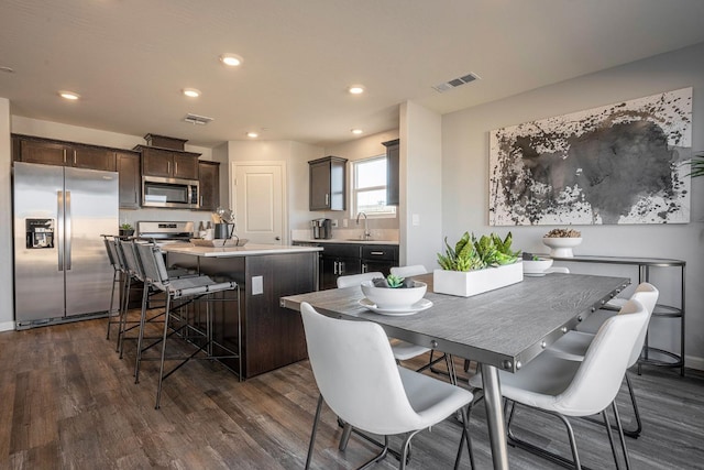 dining space featuring recessed lighting, visible vents, and dark wood-type flooring