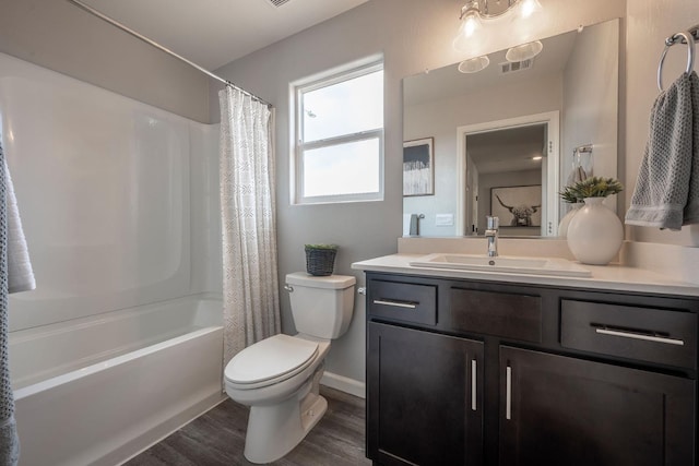 full bathroom with visible vents, toilet, wood finished floors, shower / bath combination with curtain, and vanity