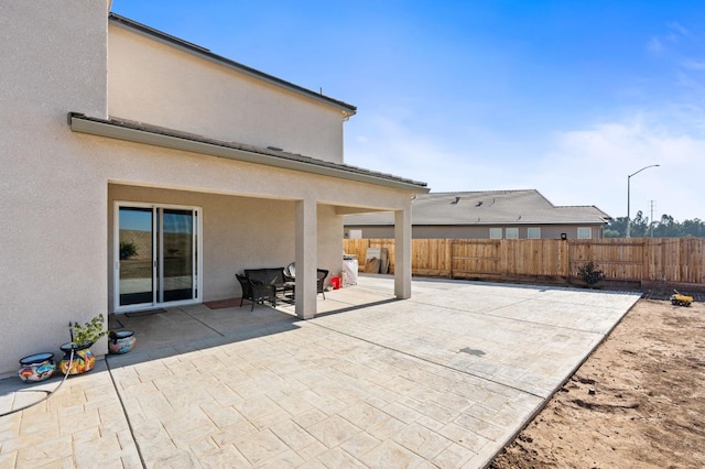 view of patio / terrace featuring fence