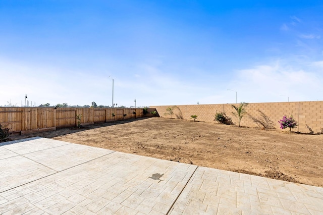 view of yard featuring a fenced backyard and a patio