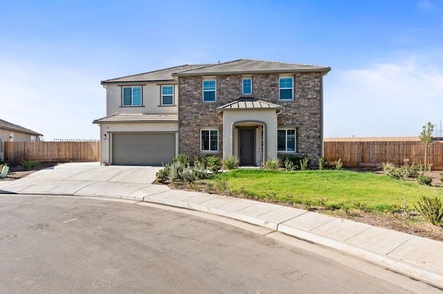 traditional home featuring concrete driveway, a garage, fence, and a front yard