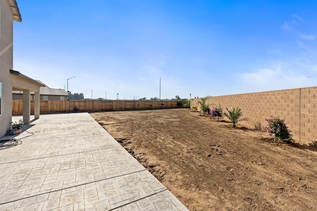 view of yard with a fenced backyard and a patio area