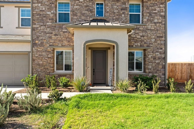 doorway to property featuring stucco siding, a lawn, a standing seam roof, fence, and metal roof