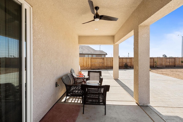 view of patio / terrace featuring an outdoor living space, a ceiling fan, and a fenced backyard