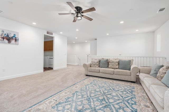 living area featuring visible vents, baseboards, recessed lighting, washer and dryer, and carpet flooring