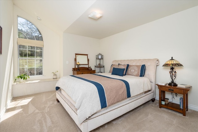 bedroom with multiple windows and carpet