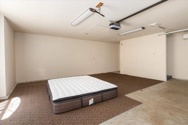 46055 Sutton Dr, Oakhurst, CA 93644 - garage with a garage door opener and a wall mounted AC