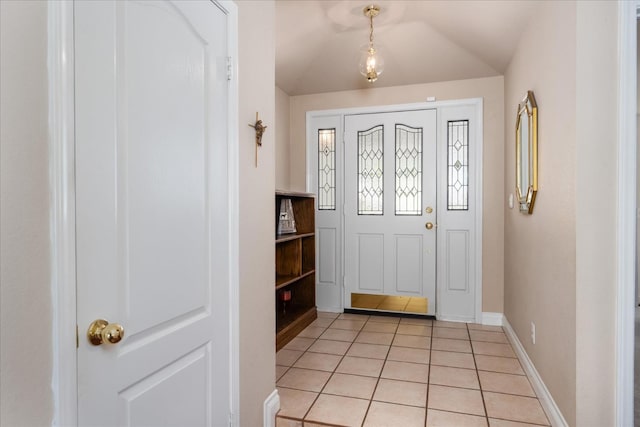 entryway with light tile patterned flooring and baseboards