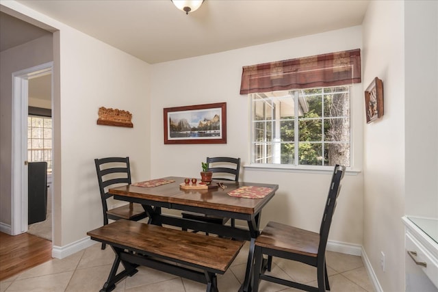 dining room with light tile patterned floors and baseboards