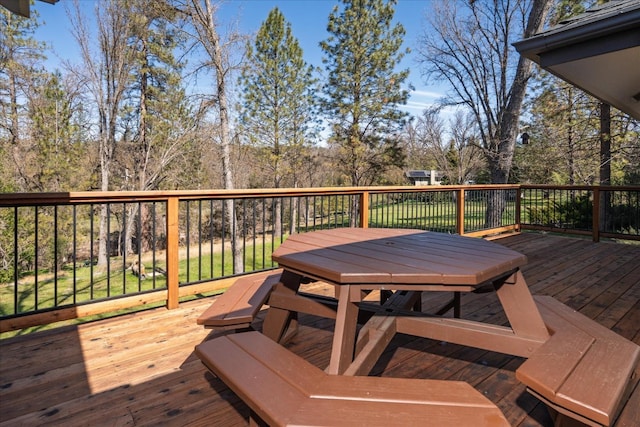 wooden deck featuring outdoor dining area