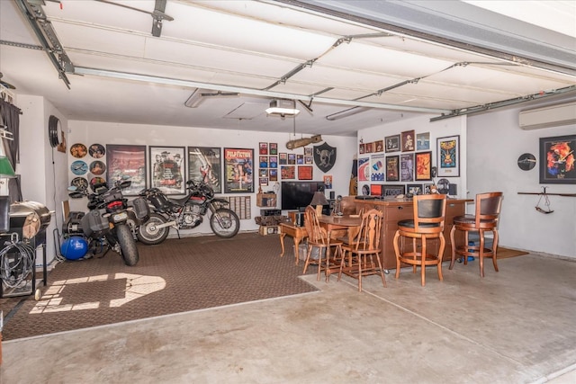 garage with a garage door opener and a wall mounted AC