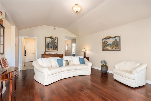 living room with dark wood finished floors, baseboards, and vaulted ceiling