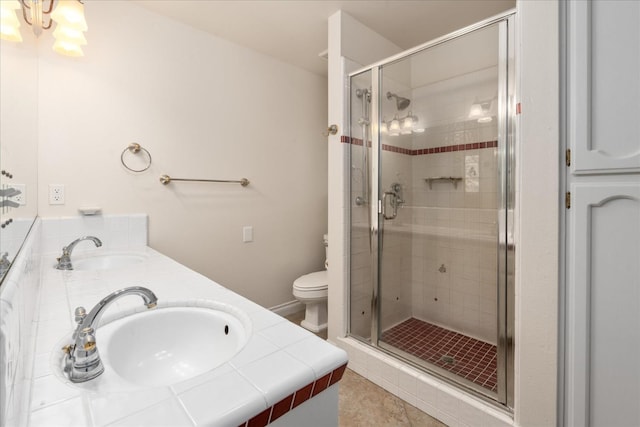 46055 Sutton Dr, Oakhurst, CA 93644 - full bath featuring a shower stall, double vanity, toilet, and tile patterned floors
