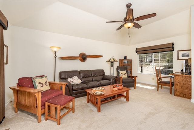 living room with light carpet, baseboards, ceiling fan, and vaulted ceiling