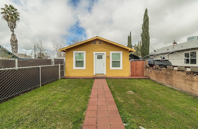 view of front facade with a front yard and a fenced backyard