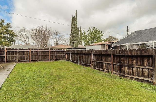 view of yard with a fenced backyard