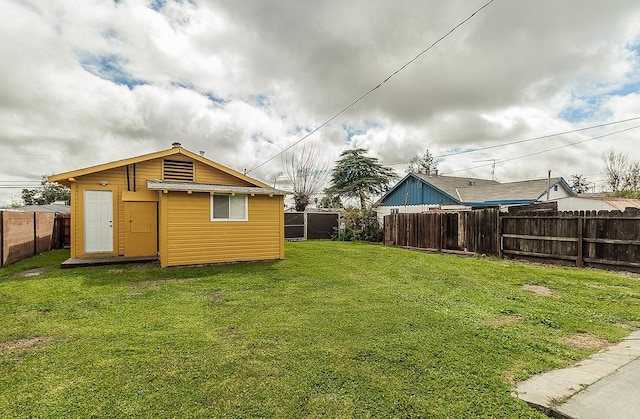 view of yard with an outdoor structure and a fenced backyard