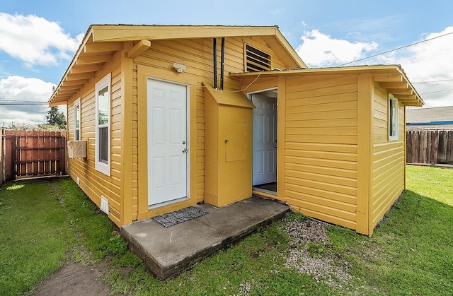 view of outbuilding featuring fence