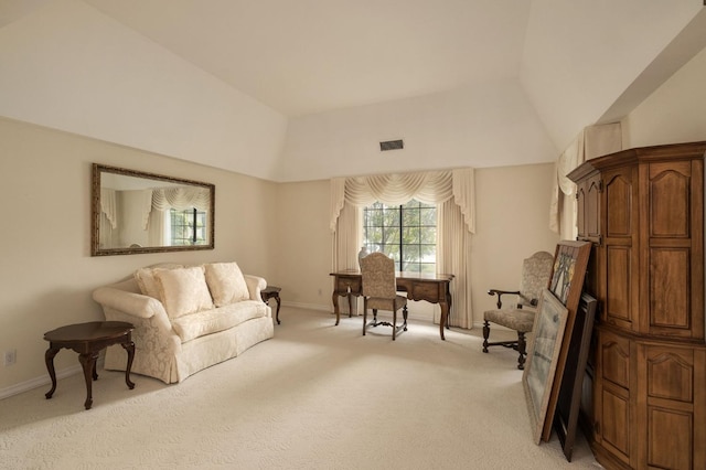 interior space featuring visible vents, light colored carpet, baseboards, and lofted ceiling