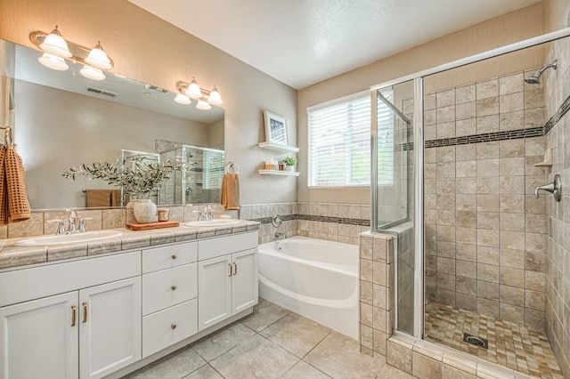 bathroom featuring a bath, visible vents, a shower stall, and a sink