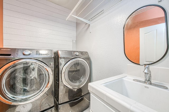 laundry area with a sink, laundry area, and washer and dryer