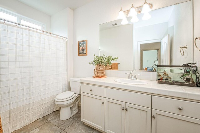 bathroom with visible vents, curtained shower, toilet, and vanity