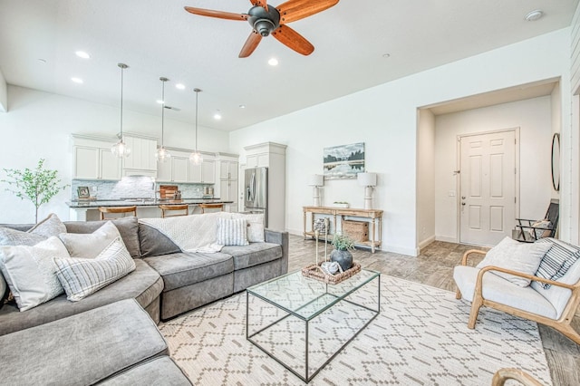 living room with recessed lighting, baseboards, and ceiling fan