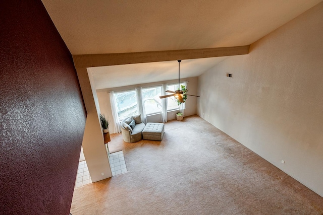 unfurnished room featuring lofted ceiling with beams, carpet floors, and a ceiling fan