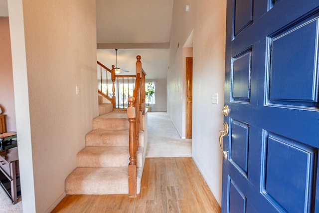 foyer entrance featuring stairs and light wood-style floors