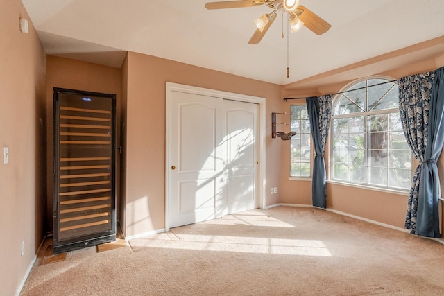 unfurnished bedroom featuring a closet, a ceiling fan, baseboards, and carpet floors