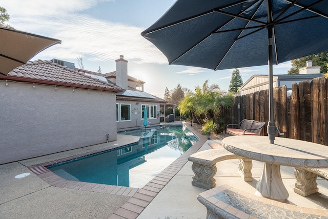 view of pool with a fenced in pool, fence, and a patio area