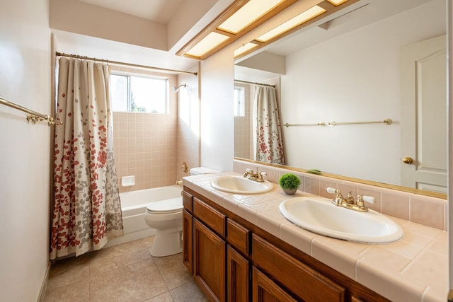 bathroom featuring a sink, shower / tub combo, toilet, and double vanity