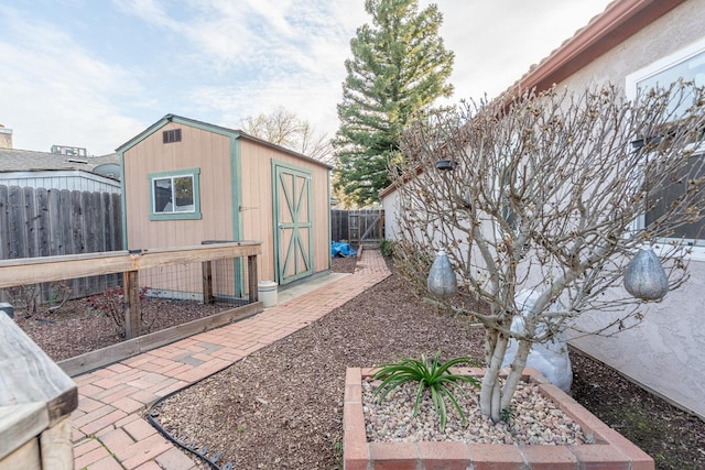 view of yard with a storage unit, an outbuilding, and a fenced backyard