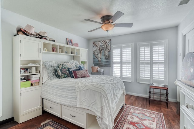 bedroom with visible vents, ceiling fan, baseboards, a textured ceiling, and dark wood-style flooring