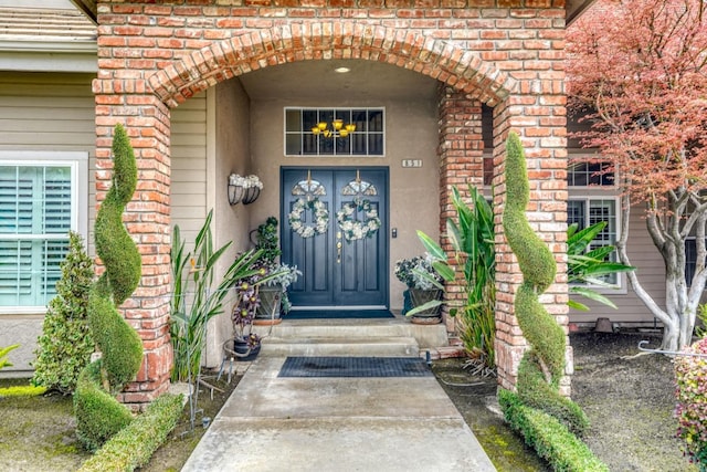 entrance to property featuring brick siding