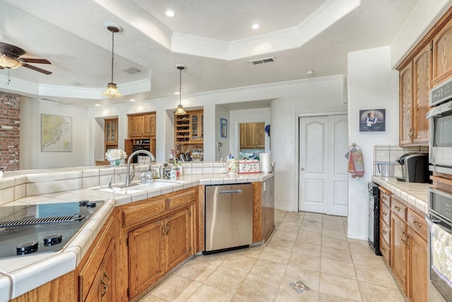 kitchen with visible vents, a sink, black electric cooktop, a raised ceiling, and dishwasher