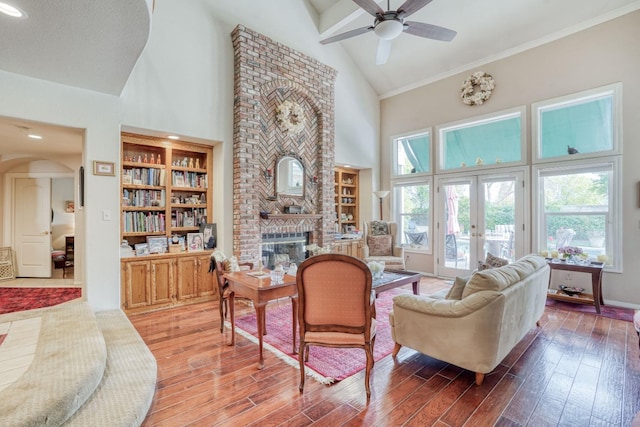 851 E Country View Cir, Fresno, CA 93730 - living area featuring high vaulted ceiling, ceiling fan, light wood-style flooring, a brick fireplace, and arched walkways