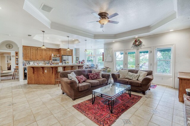 851 E Country View Cir, Fresno, CA 93730 - living area featuring a tray ceiling, ornamental molding, ceiling fan, light tile patterned floors, and a textured ceiling