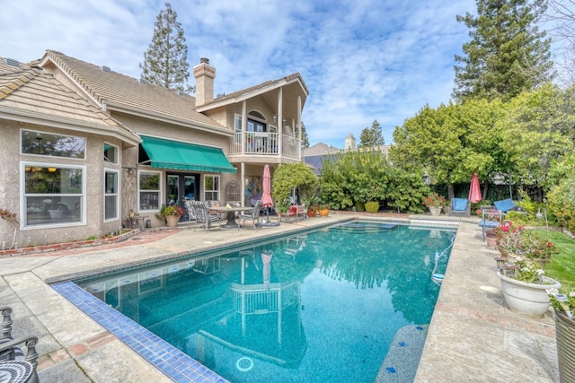 outdoor pool with a patio area